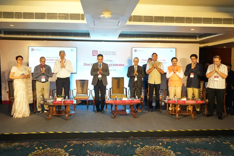 Dignitaries stand for the World Peace Prayer on stage at WPU GŌA