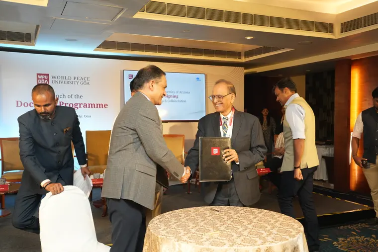Handshake after the MoU signing at the WPU GŌA doctoral launch