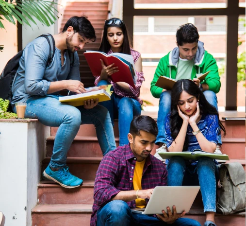 Students reading and studying together on the campus steps