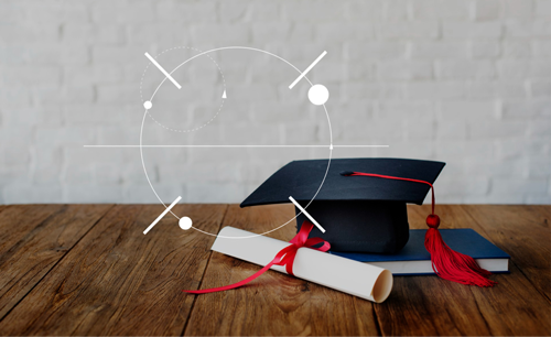 A graduation cap and diploma on a desk representing international summer schools