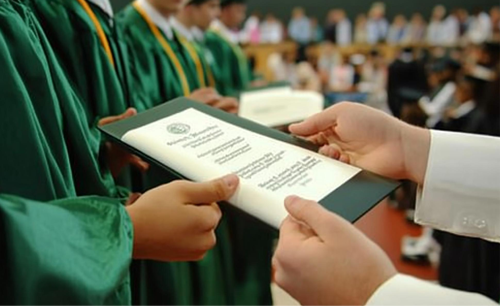 A graduate receiving a certificate at a convocation ceremony