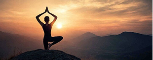 A person practising yoga at sunrise — tracking and improving personal health